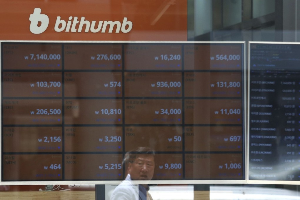A man is reflected on a screen showing the prices of bitcoin at Bithumb cryptocurrency exchange in Seoul on Wednesday. Bithumb, South Korea's second-largest exchange, said US$31 million worth of virtual currencies have been stolen by hackers, the latest in a series of recent hacks targeting digital currencies. Photo: AP