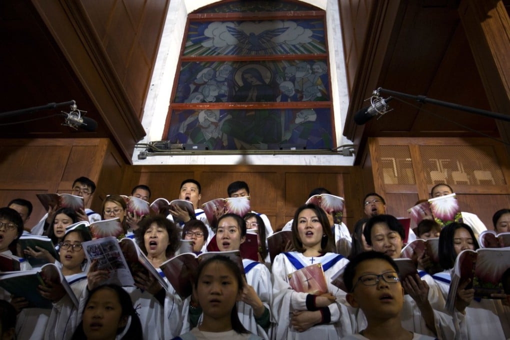 The choir sings a hymn during a Holy Saturday Mass on the evening before Easter, at the government-sanctioned Cathedral of the Immaculate Conception, in Beijing on March 31. Photo: AP