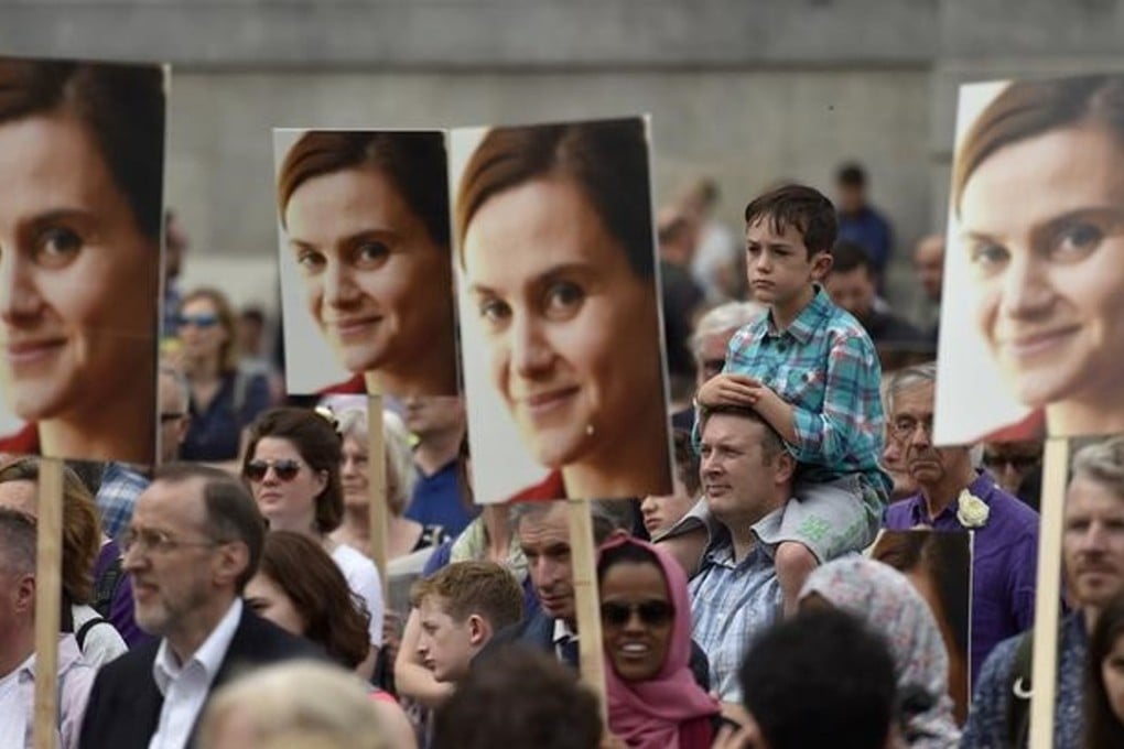 People hold banners of murdered Labour Party MP Jo Cox, during a special service at Trafalgar Square in London, Britain on June 22, 2016. Photo: Reuters