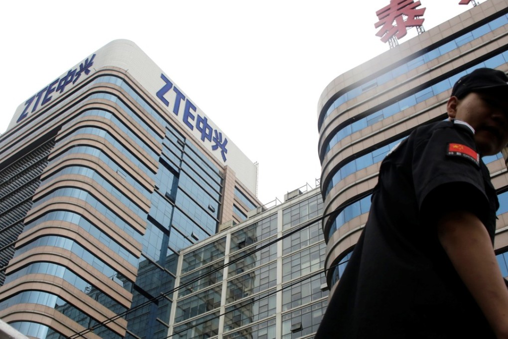 A security guard walks past a ZTE building in Beijing. Photo: Reuters