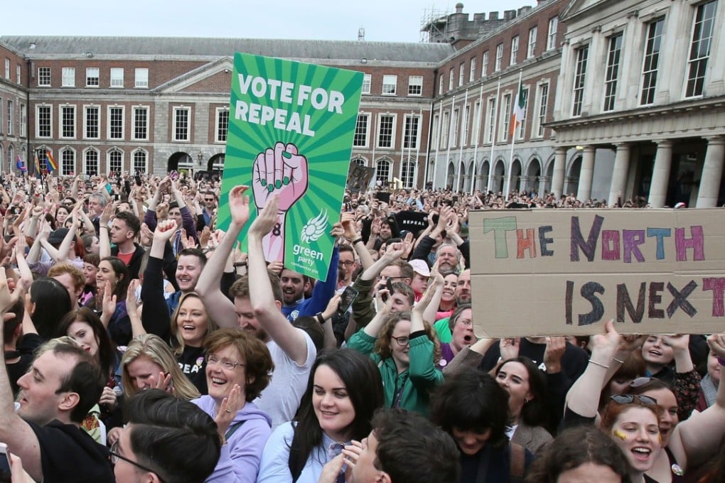 Campaigners at Dublin Castle hold posters calling for British-ruled Northern Ireland to liberalise its strict abortion laws on May 26, as an overwhelming majority of Irish citizens voted “Yes” to overturn a constitutional ban on abortion. Photo: AFP