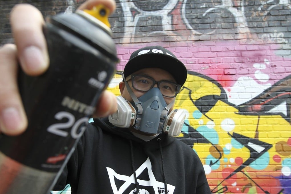 Beijing graffiti artist Andy Chen from the ABS crew in front of one of his designs. Photo: Simon Song