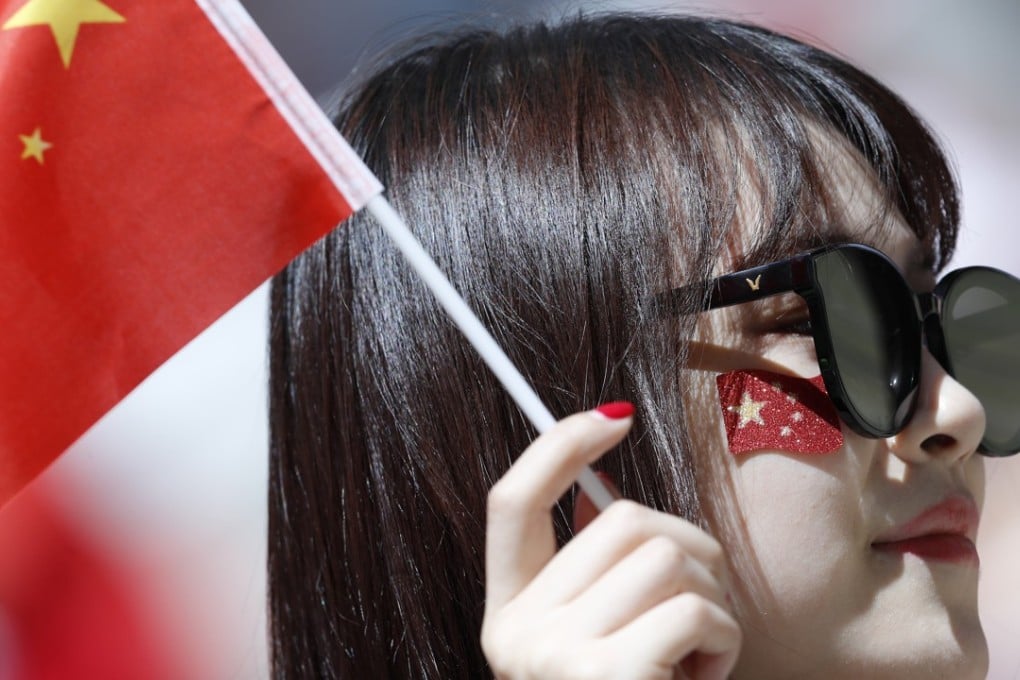 A woman holds a Chinese flag before the group B World Cup match between Portugal and Morocco at in the Luzhniki Stadium in Moscow. Photo: AP