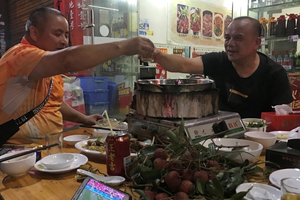 Customers raise a toast as they watch a World Cup match over a dog meat dish on Wednesday in Yulin, ahead of the festival. Photo: Reuters