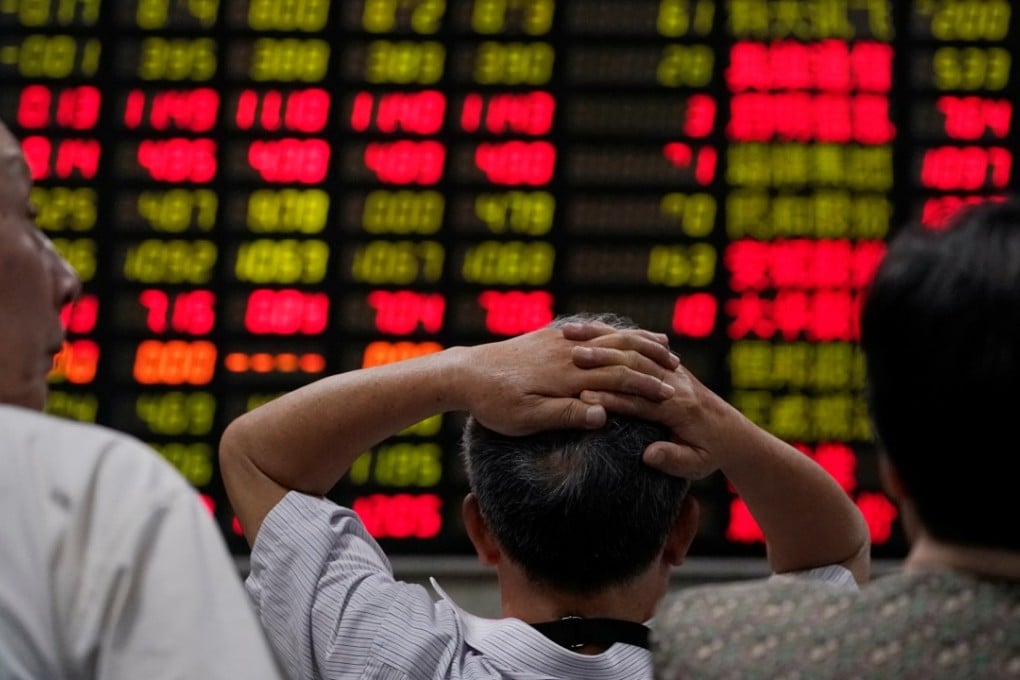 Investors look at an electronic board showing stock information at a brokerage house in Shanghai, China on Wednesday. Photo: Reuters