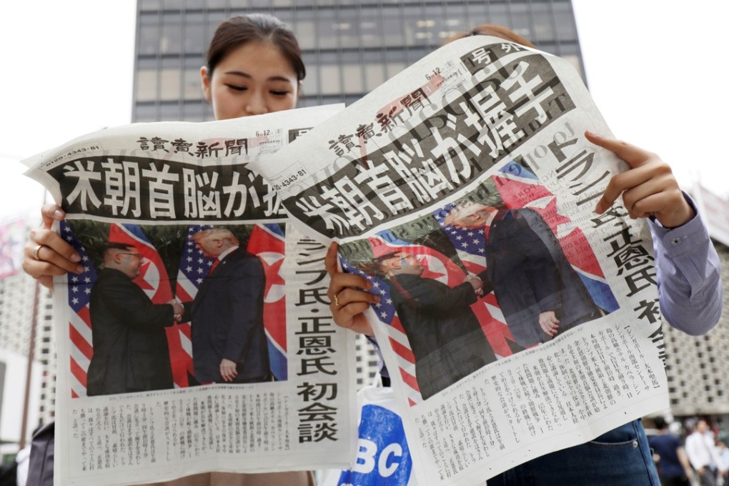 Japanese read the Yomiuri newspaper reporting about the summit between US President Donald Trump and North Korean leader Kim Jong-un. Photo: EPA