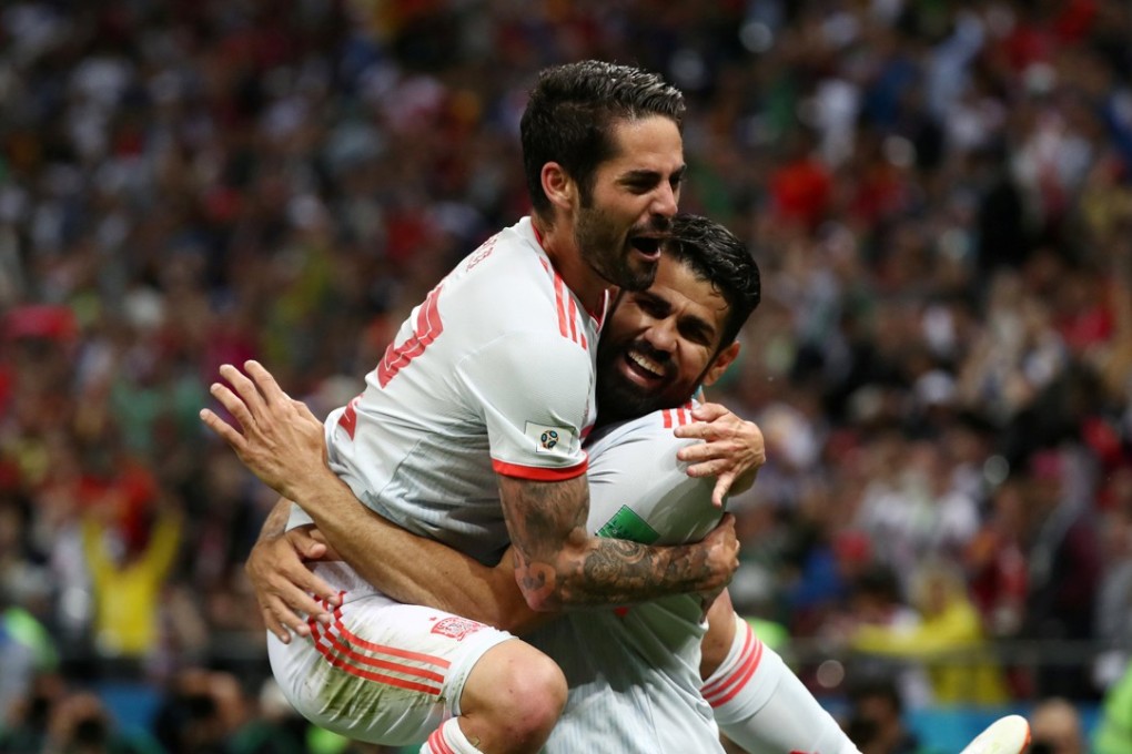Spain’s Diego Costa (below) celebrates scoring their opening goal against Iran in World Cup group B with Isco. Photo: Reuters