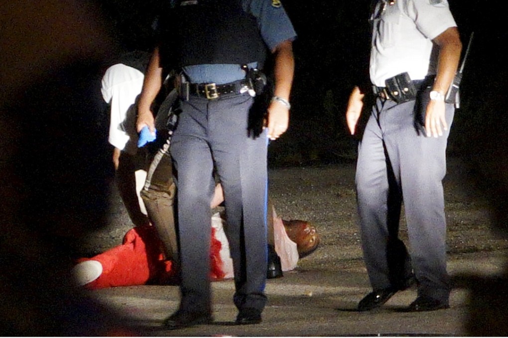 A black man lies wounded after a police officer-involved shooting in Ferguson, Missouri after a protest against the fatal shooting of unarmed black teenager Michael Brown by a white officer a year earlier. Photo: Reuters