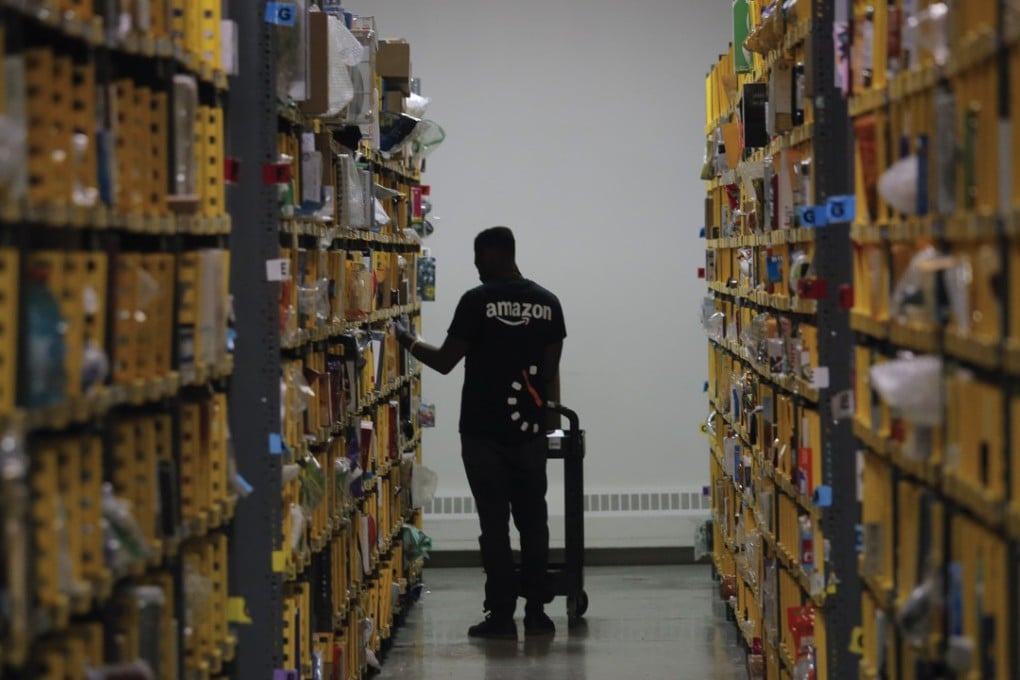 An employee of Amazon PrimeNow stacks shelves for customers at a distribution hub in New York. Photo: AP/Bebeto Matthews