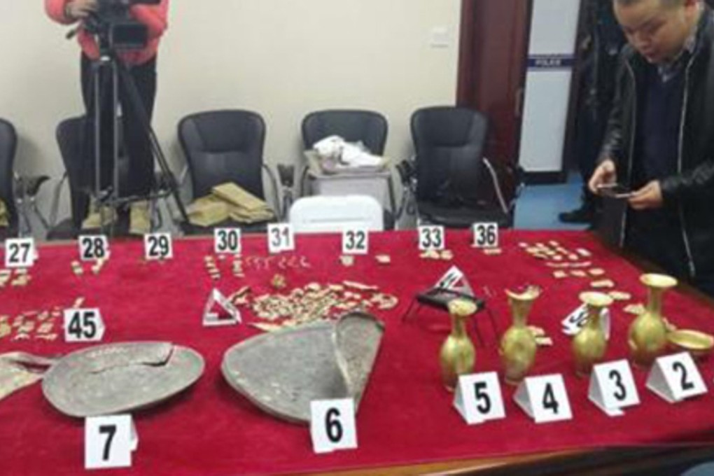 Some of the rare artefacts recovered by police, which were stolen during the raid on the tomb. Photo: CNA