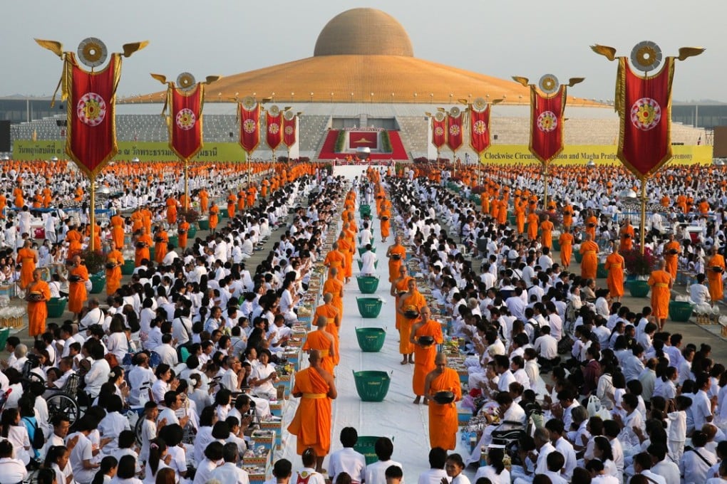 Buddhist monks at an alms offering at Wat Phra Dhammakaya in Pathum Thani, Thailand. Photo: Reuters