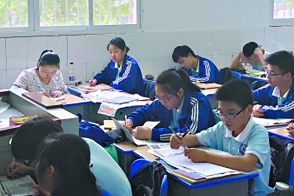 Dai Jihua sits in on her son’s class in Wuhan, Hubei province. Photo: Sina.com.cn
