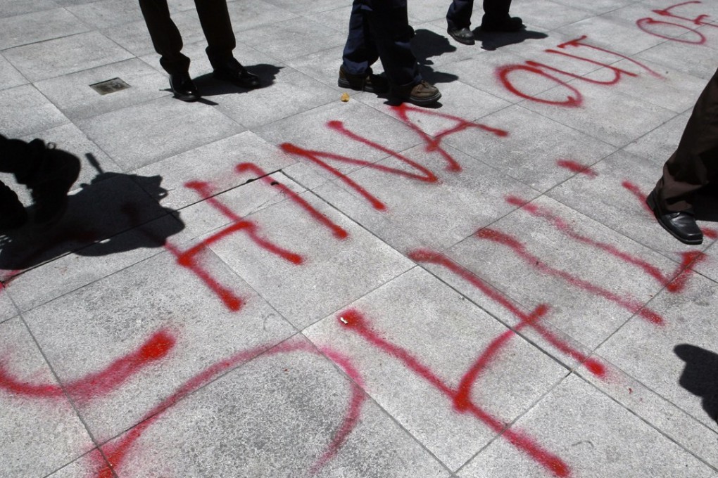 Graffiti in front of the Chinese consulate demands the withdrawal of Chinese ships from the disputed Scarborough Shoal during a 2012 protest. Photo: Reuters