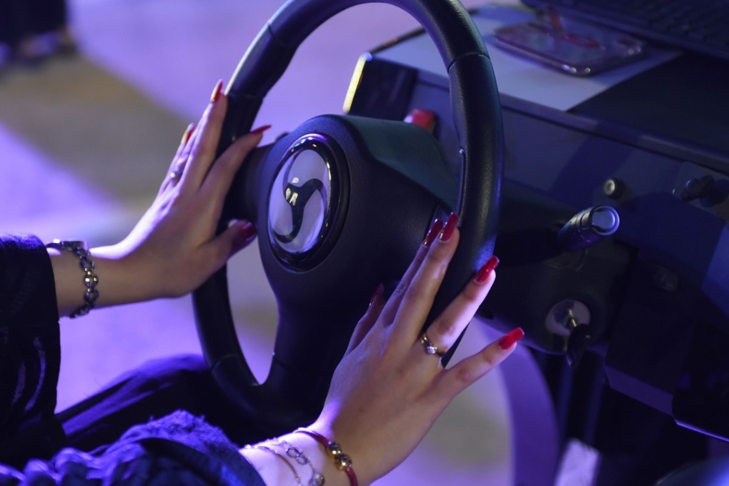 A Saudi woman using an electronic driving simulator during a workshop in Riyadh on June 21, 2018. Photo: AFP