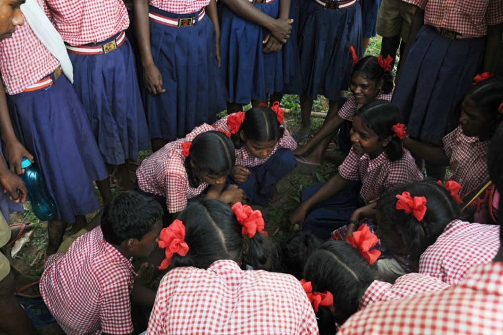 Schoolchildren and residents attend a village meeting after the abduction and gang-rape of five charity workers in Chochang village in Jharkhand State, India, on Friday. Photo: AFP