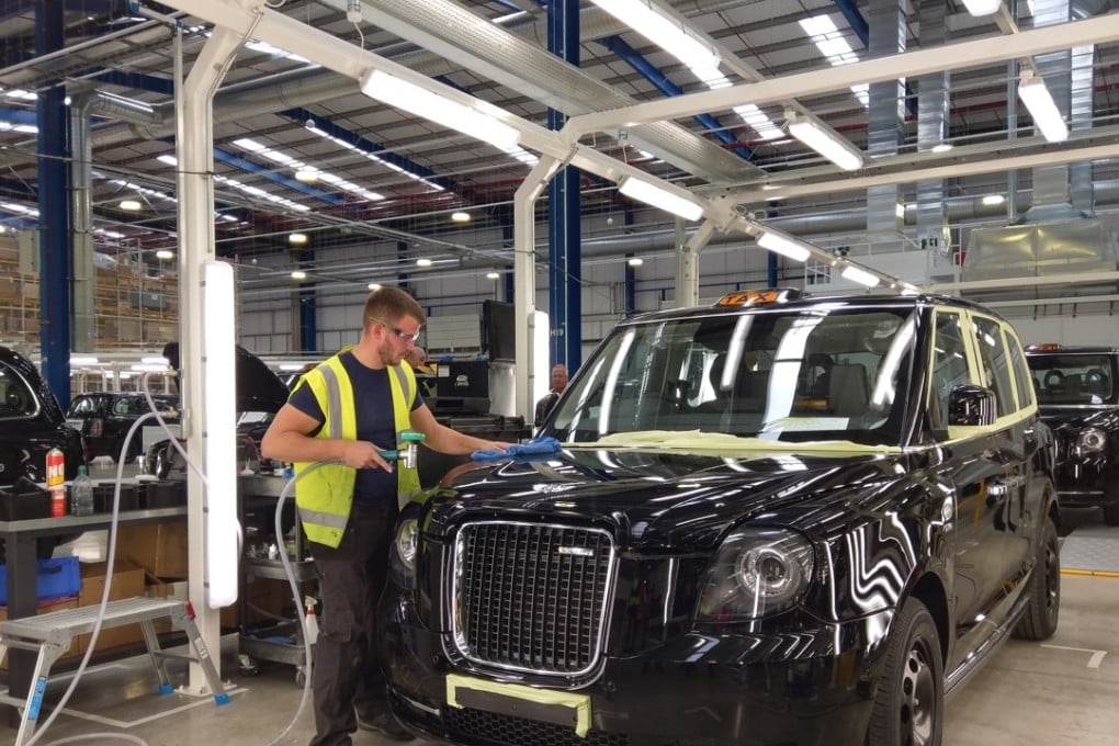 Worker polishing an electric-petrol hybrid version of the London black taxi at the new factory of Zhejiang Geely's London Electric Vehicle Company in Coventry in the British Midlands on 18 May 2018. Photo: SCMP/Eric Ng