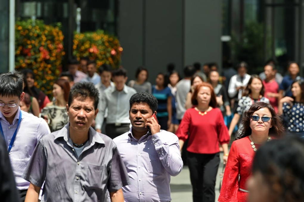 Workers in Singapore’s financial district. Photo: AFP