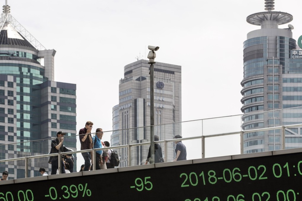 An electronic ticker displays stock market figures in Shanghai’s financial district. The Shanghai Composite Index retreated by 1.1 per cent on Monday. Photo: Bloomberg