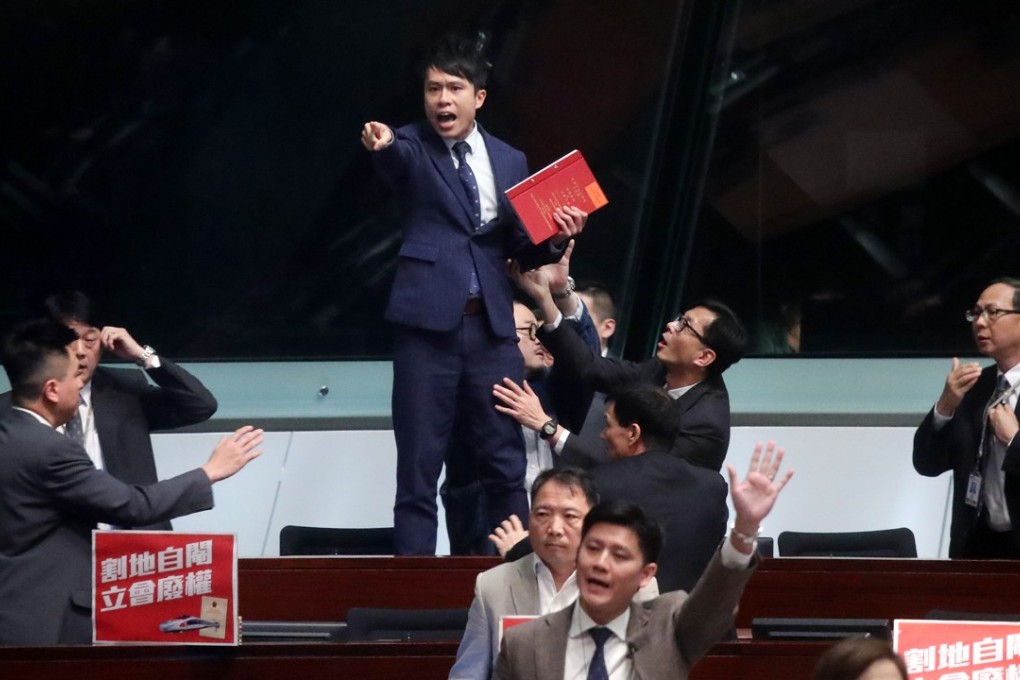 Lawmaker Roy Kwong Chun-yu protests against a ruling from Andrew Leung, the Legislative Council president, during a meeting in Legco. Photo: K.Y. Cheng