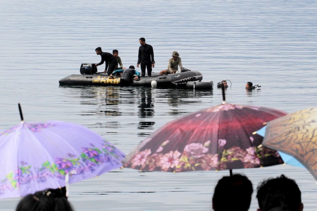 Relatives of the victims of the sunken ferry wait for news as search operations continue. Photo: EPA
