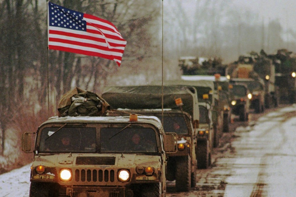 A humvee flying the American flag leads a convoy of vehicles with the US Army’s first armoured division down a road leading to the pontoon bridge which crosses the Sava River into Bosnia from Zupanja, Croatia, on January, 1996. Photo: AP