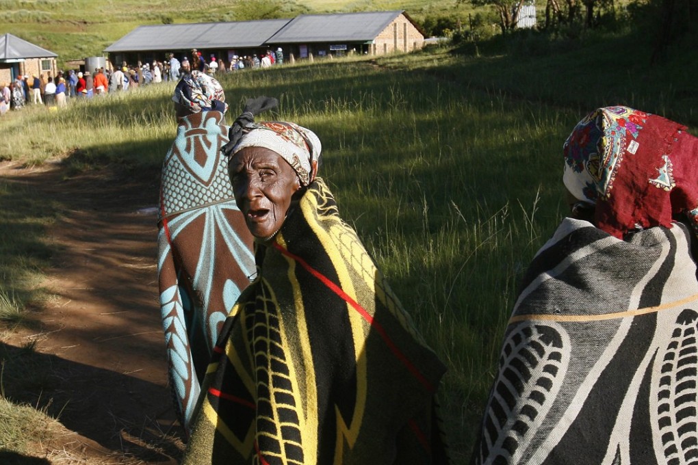 Women walk to a polling station in Lesotho, southern Africa, where they are barred from owning land independently. Photo: AP