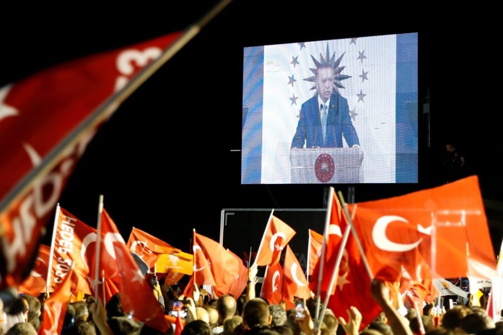 Turkish President Tayyip Erdogan is seen on the screen as he addresses his supporters in Istanbul, Turkey June 24, 2018. REUTERS/Alkis Konstantinidis