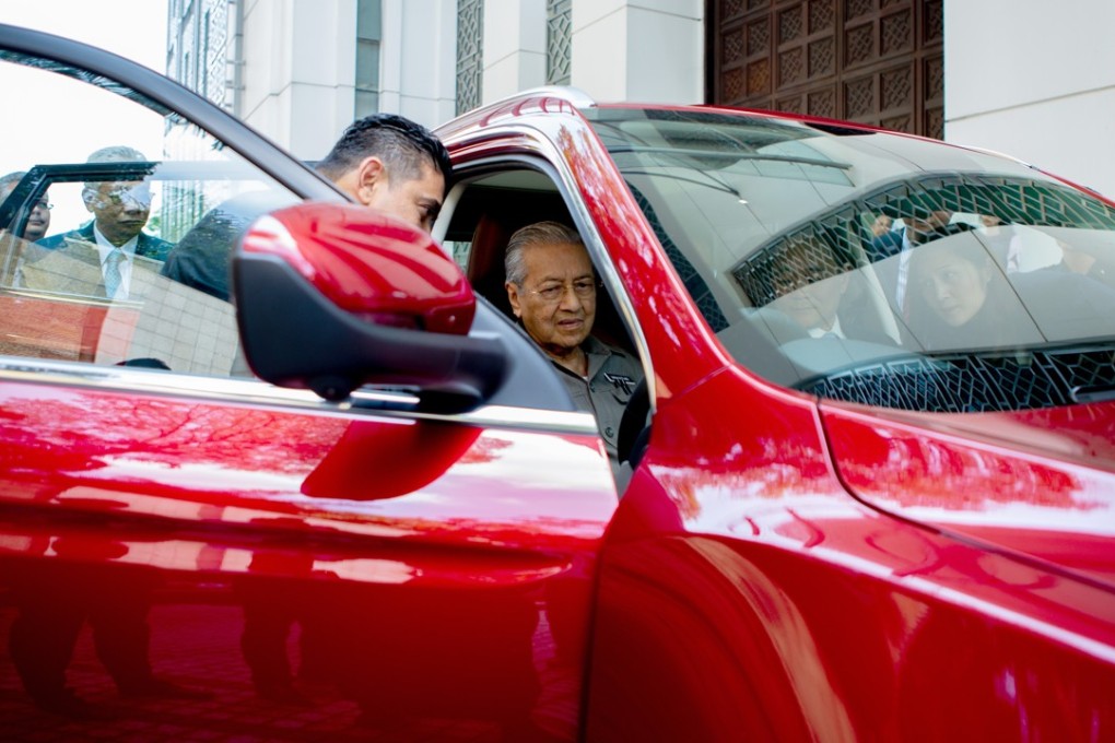 Malaysia’s Prime Minister Mahathir Mohamad in the new Proton Holdings sport utility vehicle. Photo: Bloomberg
