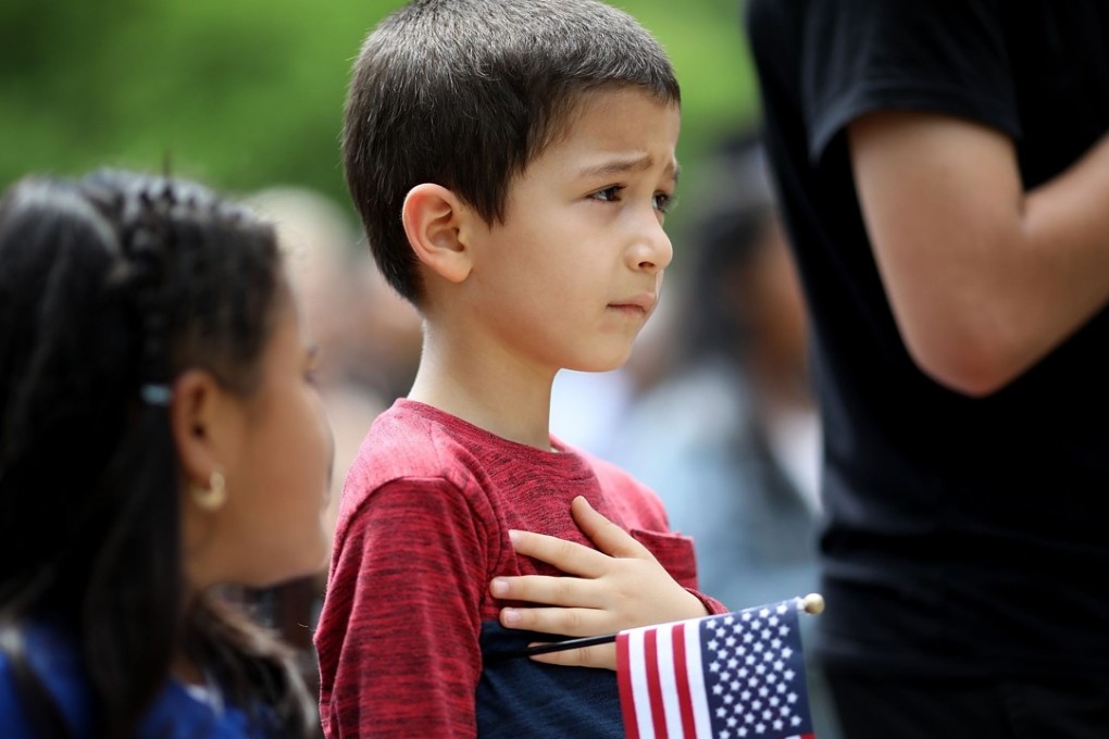 Children recite the Pledge of Allegiance during a citizenship ceremony on May 31 in Washington. Photo: Getty Images via AFP