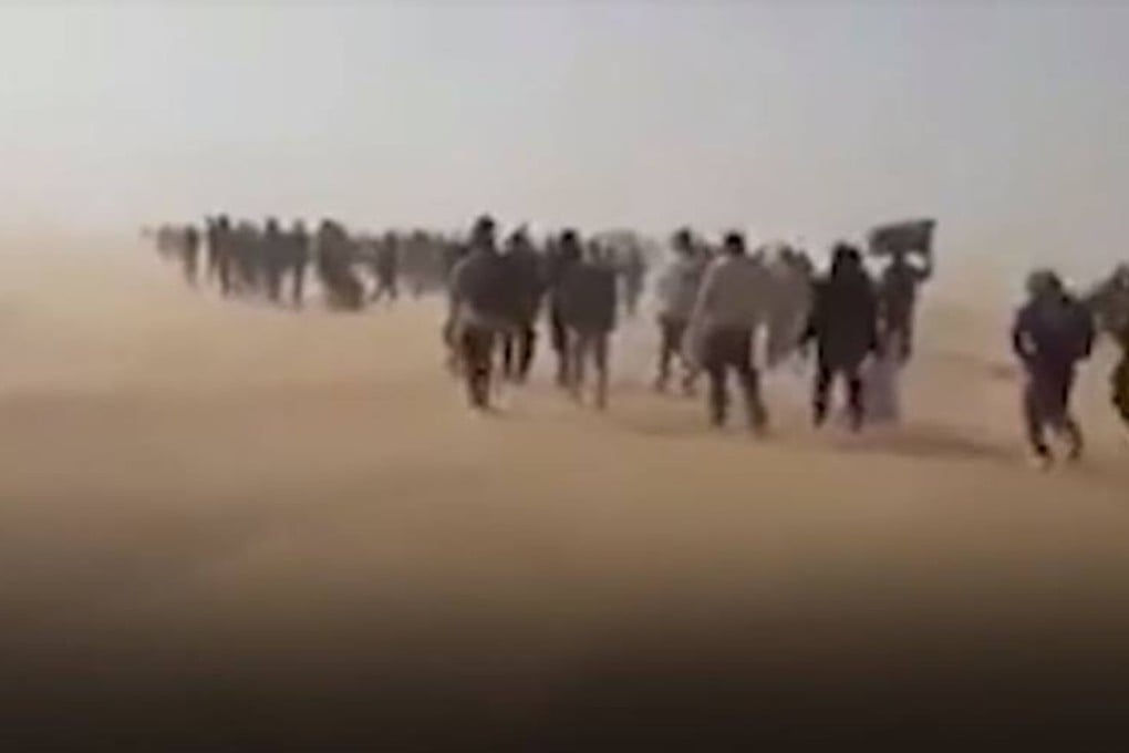 Migrants expelled from Algeria are forced to walk into the Sahara Desert, in this screenshot from video. Photo: AP / Ju Dennis