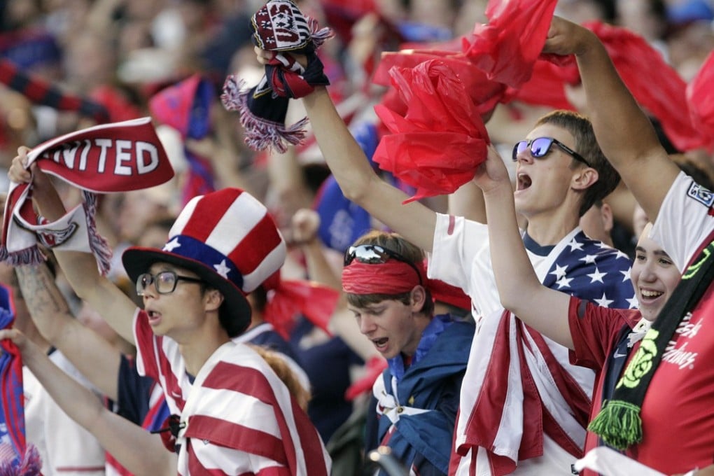 US fans cheer their team during the first half of a CONCACAF Gold Cup soccer match between the United States and Belize in Portland, Oregon, in July 2013. The US soccer team may not have qualified for the 2018 Fifa World Cup, but the economy and the US dollar are doing well. Photo: AP