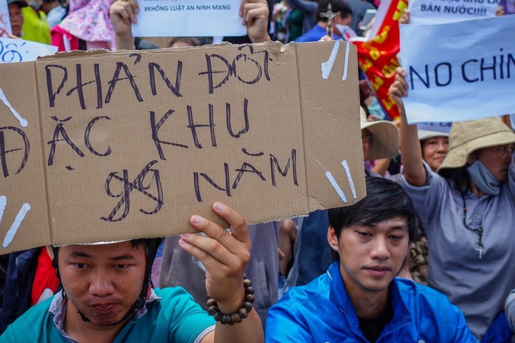 A Vietnamese protester holds a placard reading 'Against leasing land in special economic zones for 99 years' during a rally in Ho Chi Minh city against a draft law on the Special Economic Zone on June 10, 2018. Photo: EPA-EFE/STR