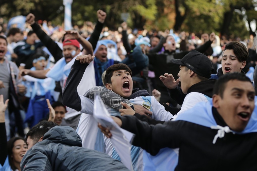 Argentina fans celebrate Lionel Messi’s opening goal against Nigeria. Photo: AP