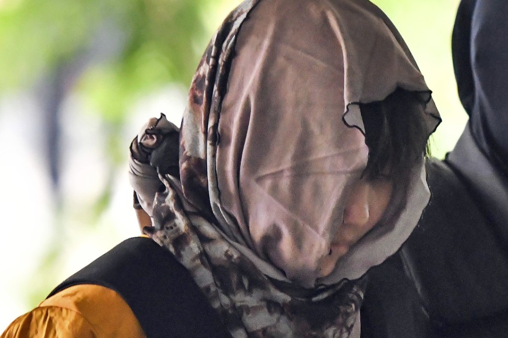 Vietnamese Doan Thi Huong is escorted by police to the court. Photo: AP