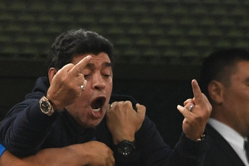 Retired Argentina legend Diego Maradona makes an obscene gesture as he celebrates Argentina’s dramatic win against Nigeria. Photo: AFP