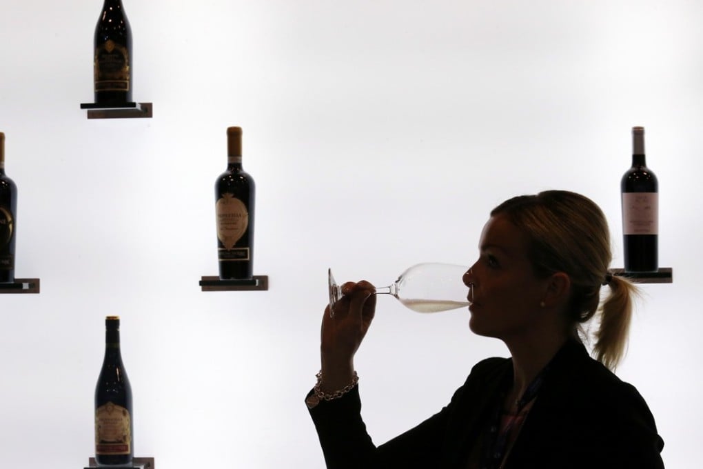 A visitor samples wine at Vinexpo, at the Hong Kong Convention and Exhibition Centre, in Wan Chai, on May 30, 2018. Hong Kong is the region’s trading hub for wines and spirits. Photo: Felix Wong