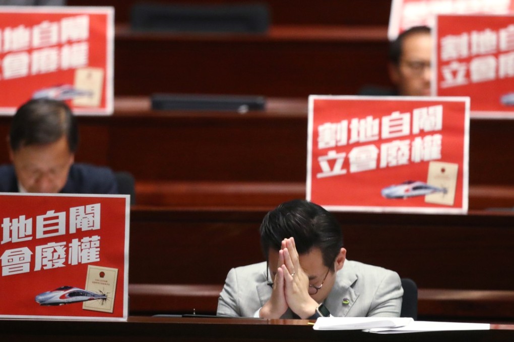 Lawmaker Alvin Yeung Ngok-kiu (front) bows his head during a Legislative Council meeting at the Legislative Council complex in Tamar, Admiralty, on the Guangzhou-Shenzhen-Hong Kong Express Rail Link (Co-location) Bill on June 14. Photo: Nora Tam
