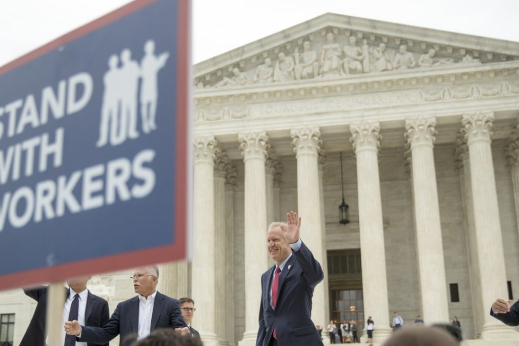 Illinois Governor Bruce Rauner (center, waving) leaves the US Supreme Court after the justices ruled that states cannot force government workers to pay union fees, a decision he supported. Photo: AP