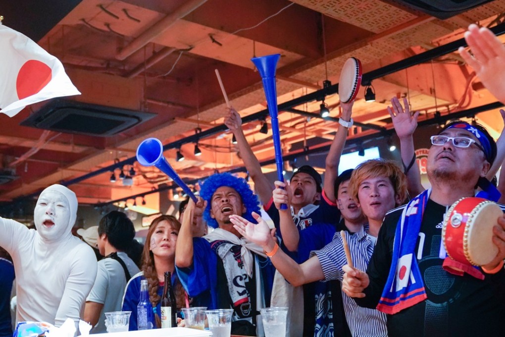 Japanese fans watch the World Cup match against Poland in the Hooters restaurant in Shibuya, Tokyo. Photo: EPA