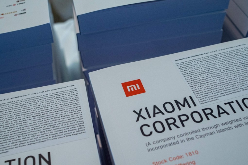 The prospectus for the initial public offering (IPO) for Chinese smartphone maker Xiaomi is pictured during a press conference in Hong Kong on June 23, 2018. Chinese smartphone maker Xiaomi kicked off its initial public offering on June 21 but the firm is likely to pull in about 6.1 billion USD, far less than originally expected, with investors having mixed views about its main business. Photo: Agence France-Presse