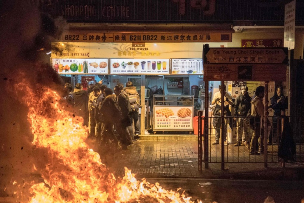 A fire started by protesters burns in the street during clashes between demonstrators and police in Mong Kok over the Lunar New Year holiday in 2016. Activist Edward Leung was jailed for six years on June 11 for his involvement in the riot. Photo: AFP
