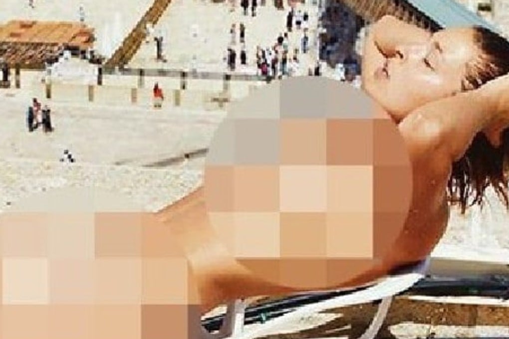 A picture in Belgian newspaper HLN of Marisa Papen leaning back nude on a lounger, on a rooftop overlooking Jerusalem's Western Wall, has sparked outrage in Israel. Photo: HLN