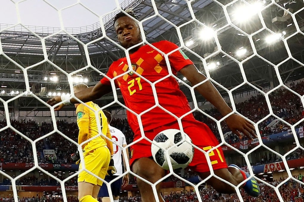 Michy Batshuayi kicks the ball in celebration after teammate Adnan Januzaj scores Belgium’s goal, but he gets a nasty surprise. Photo: Reuters