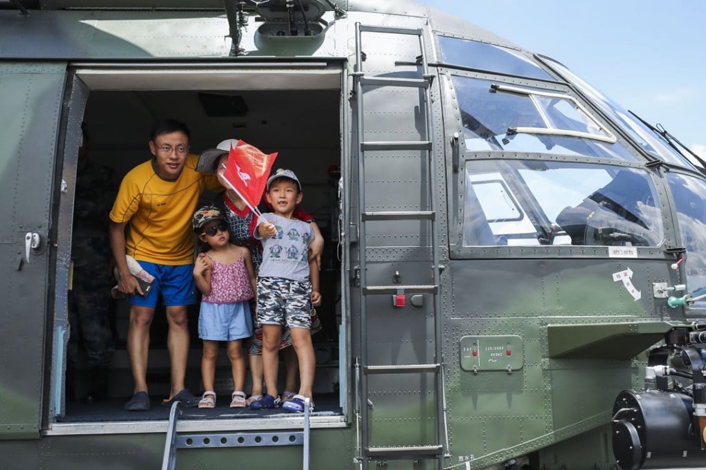 Visitors aboard a PLA helicopter at Shek Kong in the New Territories. Photo: Winson Wong