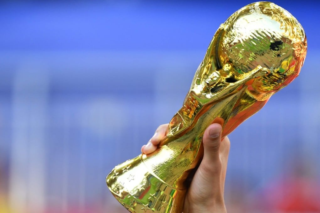A replica of the World Cup trophy is brandished by a football fan at Russia 2018. Photo: AFP