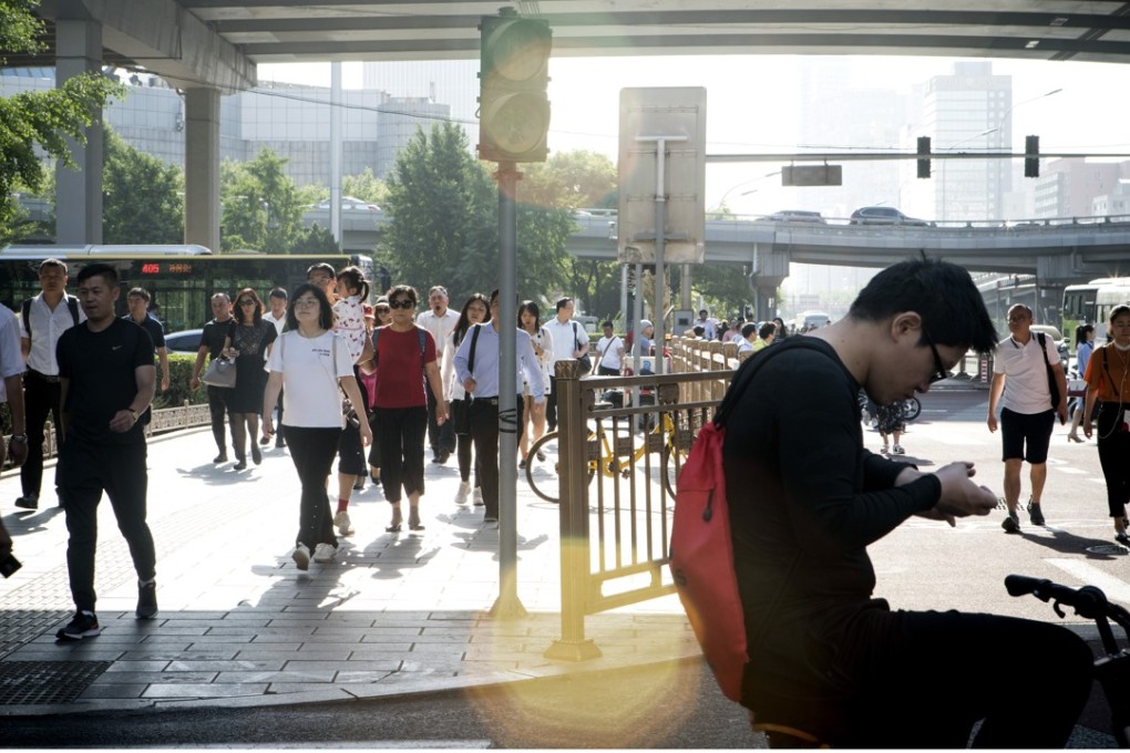 Pedestrians in Beijing’s central business district. Sun Life Everbright Life Insurance has increased its footprint across China since 2010, obtaining licences for 22 provinces and municipal cities. Photo: Bloomberg