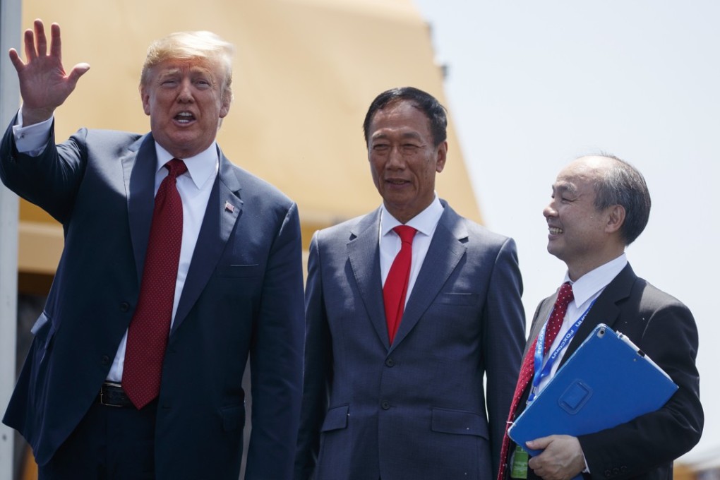 US President Donald Trump waves to reporters while standing with Foxconn chairman Terry Gou(centre) and CEO of SoftBank, Masayoshi Son, during a groundbreaking event on Thursday, June 28, 2018, in Mt. Pleasant, Wisconsin state. Photo: AP
