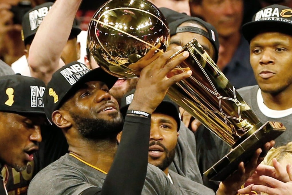 LeBron James hoists the Larry O’Brien trophy after defeating the Golden State Warriors to win the NBA Finals in 2016. Photo: AFP