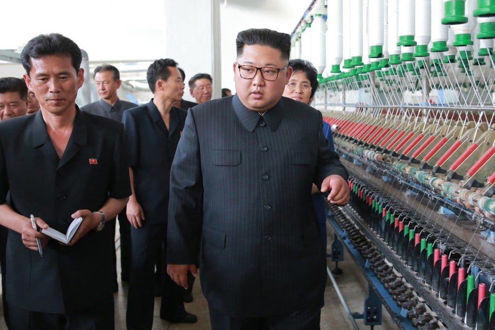 North Korean leader Kim Jong-un (centre) visits a textile company in Sinuiju on Sunday. One of his top economic advisers arrived in Beijing on Monday for more talks with Chinese officials. Photo: AP