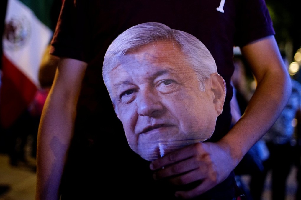 A supporter of presidential candidate Andres Manuel Lopez Obrador carries a cut-out of the candidate in downtown Mexico City on Sunday. Photo: Reuters